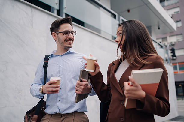 istock Two young professionals walking and talking during coffee break 2218966609