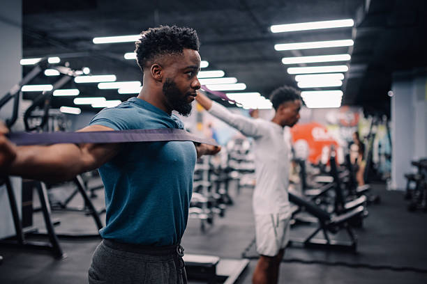 istock Determined young man performing resistance band exercises in gym 2218966821