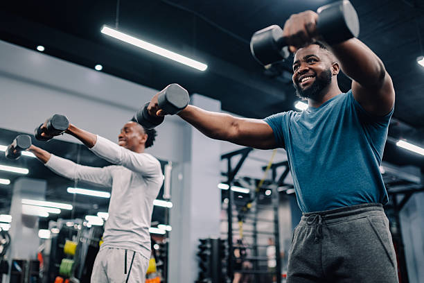 istock Two young men lifting weights in the gym 2218966865