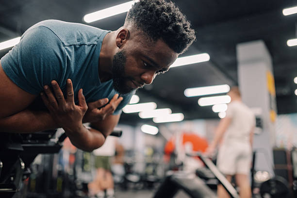 istock Young man suffering chest pain after intense workout in gym 2218966910