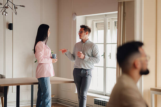 istock Business colleagues engaging in casual conversation during office break 2218967315