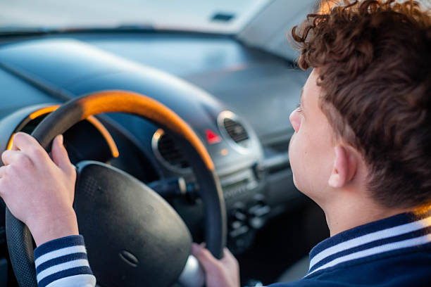 istock A teenager drives a car. 2218968098