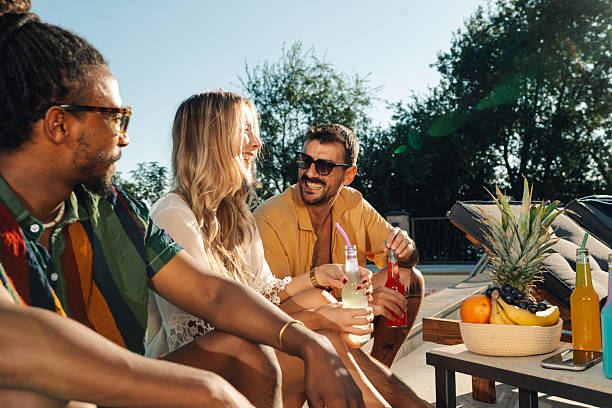 istock Friends enjoying refreshing drinks by the pool 2218970466