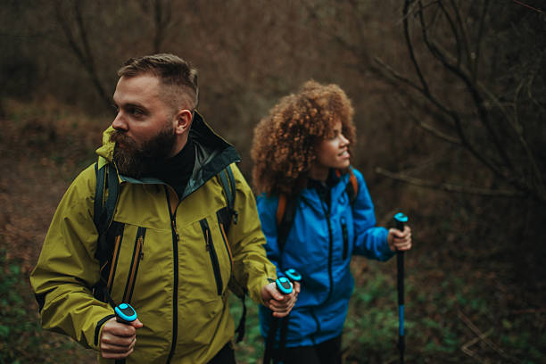 istock Hikers walking in forest using trekking poles 2218970651