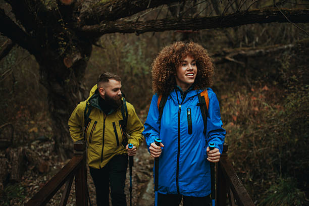 istock Hikers walking on wooden bridge in forest trail 2218970671