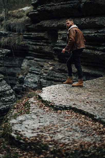 istock Young male hiker walking on a cliff in a canyon 2218970712