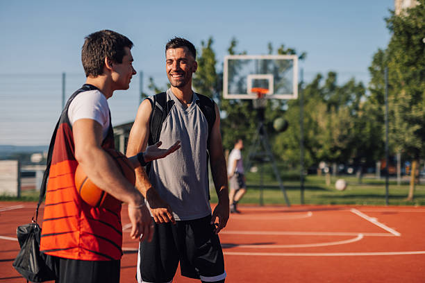istock Two basketball players talking on court after training 2218970829