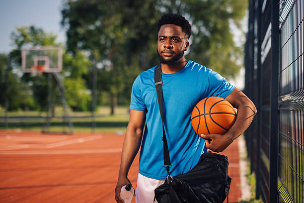 istock Basketball player holding ball and water bottle after training 2218970845
