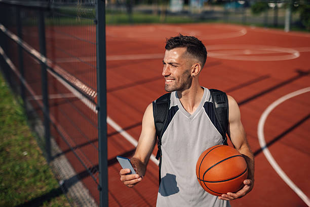 istock Basketball player using smartphone on outdoor court 2218970851