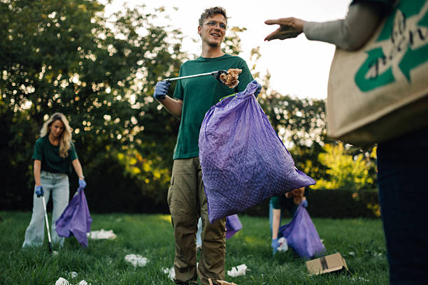 istock Volunteers collecting trash in park using trash picker and bags 2218970953