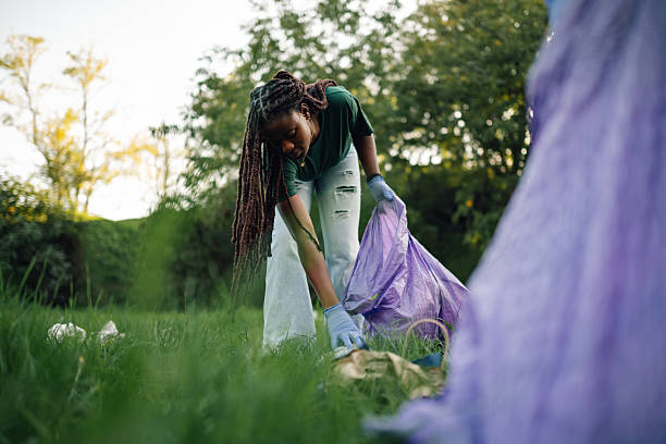 istock Volunteer picking up trash in a public park 2218970967