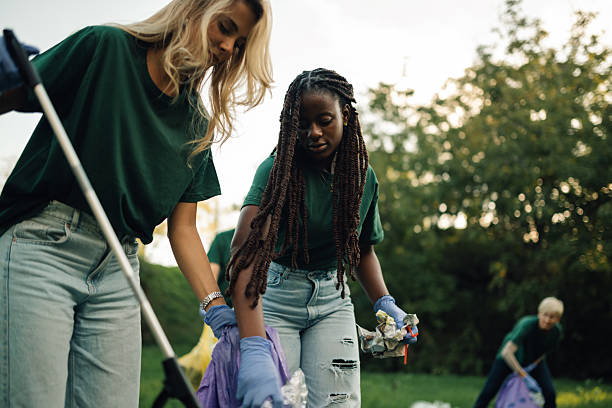 istock Volunteers picking up trash in a public park 2218970990