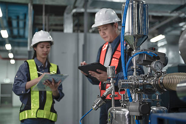 istock engineer on industry  plant. Engineers Inspecting Modern Industrial Facility 2218971822