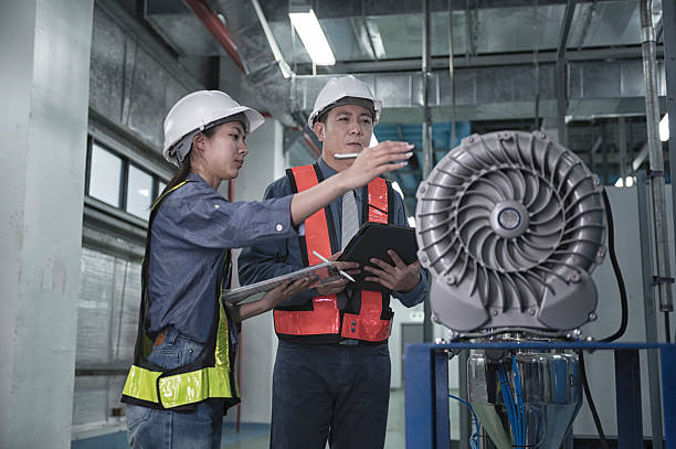 istock engineer on industry  plant. Engineers Inspecting Modern Industrial Facility 2218971826