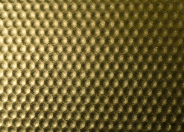Golden textured background with raised, rounded hexagons. Evokes strength, structure, and honeycomb. Ideal for technology, industry, or abstract concepts.