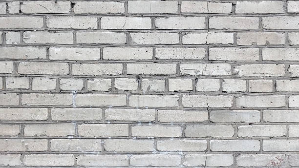istock Detailed, textured white brick wall background. Architecture, construction, and design asset. Use as backdrop, texture, or metaphor for strength and stability. 2218979063