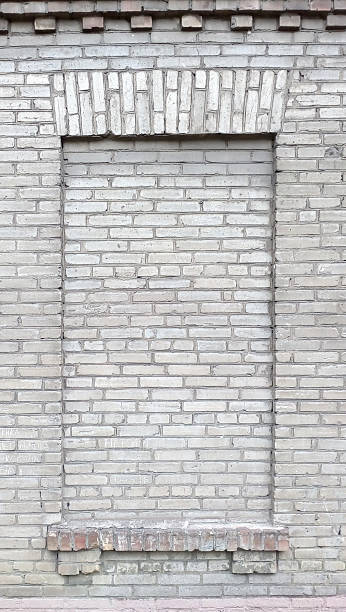 istock Brickedup window in an aged, weathered brick wall. Represents closure, abandonment, or a hidden past. Great for urban, architectural, or conceptual projects. 2218979065