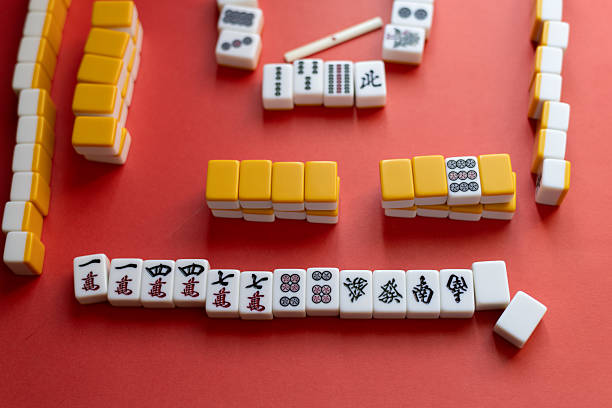 istock Mahjong tiles lined up on a red background 2218983489