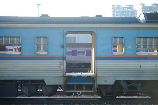 istock Thai diesel multiple unit train crossing an urban overpass. 2218985865