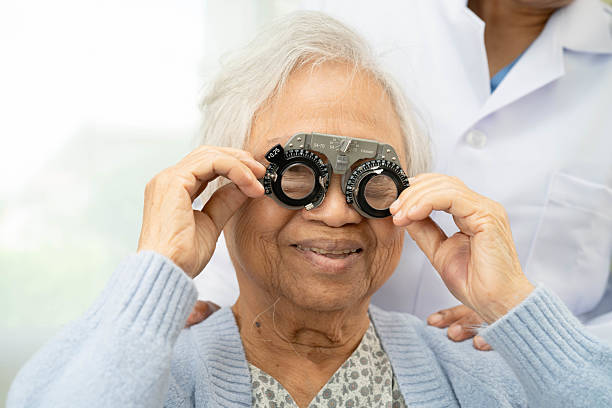istock Optometrist checking Asian elderly woman ophthalmic vision eye test and using optical trial frame. 2218988363