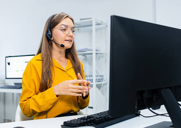 istock Woman Customer support, call center with headset working in office, consulting client, talking online, support service looking at computer screen at desk. 2218989450
