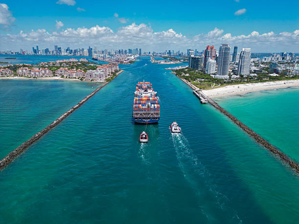 Miami, Florida, USA - June 06, 2024: Cargo ship with container in Miami, aerial view. Freight container loaded on cargo vessel in Miami. Aerial view cargo ship entering port of Miami. Container ship.