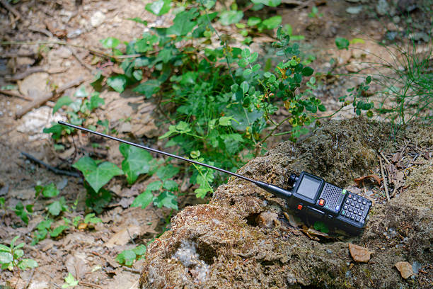 istock Portable radio transceiver lying on a rock in the forest 2218992351