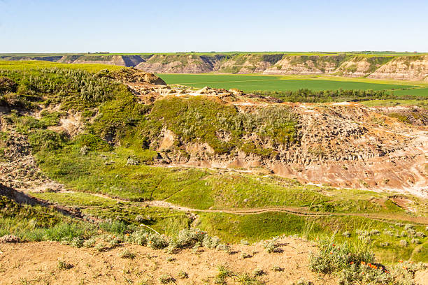 A lookout point of the multicolored badlands and prairie farmland in summer