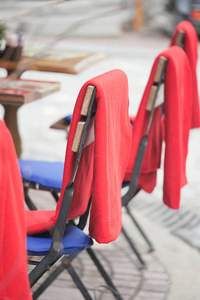 istock Colorful outdoor chairs with red blankets on a cool day 2218995972
