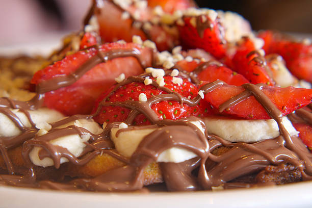 A tempting dessert features fresh strawberries and creamy chocolate sauce.