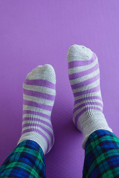 istock Colorful socks resting on a purple background with checkered pants 2218997963