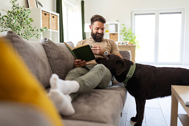 istock Peaceful Afternoon Reading with a Loyal Canine Companion 2218998114