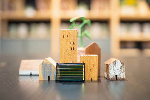 istock A wooden house model and a tree model are positioned beside small solar cells, effectively illustrating the concept of clean and renewable energy. 2219000914