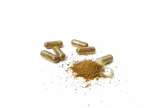 istock Alternative medicine herbal capsules isolated on white background 2219002697