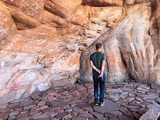 istock Man exploring sandstone cave formations with cave paintings  in the scenic Cederberg wilderness 2219009358