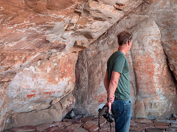 istock Man exploring Bushmen San rock art in the Cederberg wilderness cave 2219009360