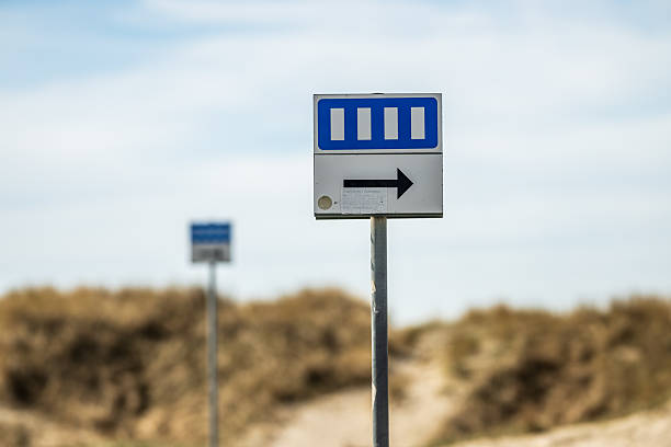 An asphalt road with a sign indicating the direction of the curve
