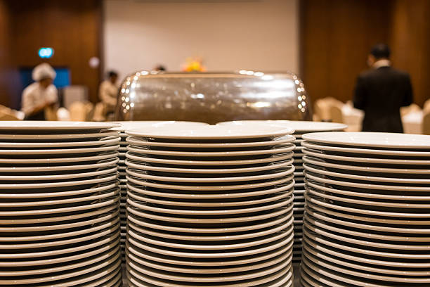 A lot of white clean plates ready to use. Restaurant utensils