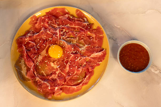istock Marinated beef topped with egg yolk prepare for sukiyaki 2219013939