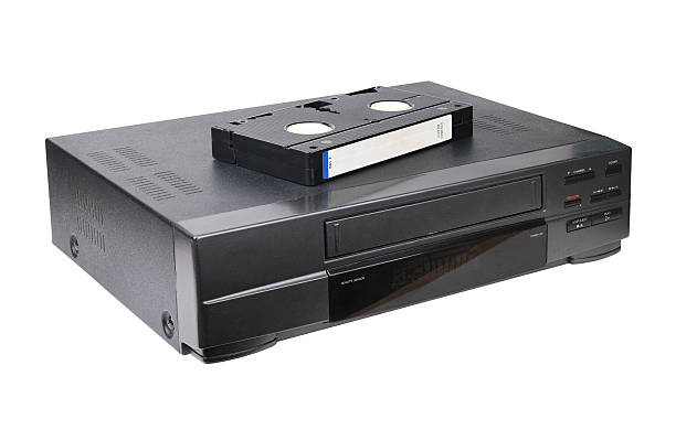 istock Classic VCR with cassette lying on top isolated on white background. 2219016153