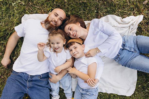 istock Happy Family lying on Grass enjoying sunny Day 2219017090