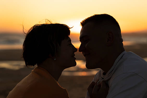 istock Young couple sharing intimate moment at sunset on beach 2219017946