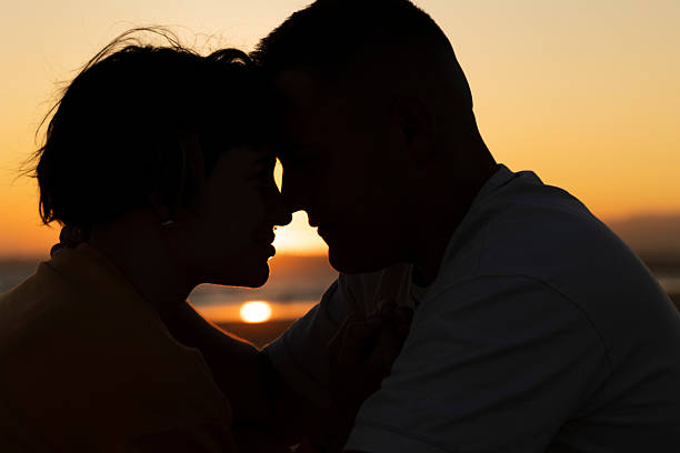 istock Romantic couple sharing intimate moment at sunset on beach 2219018345