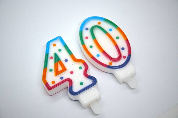 istock Number 40 birthday candle close up with white background. 2219019721