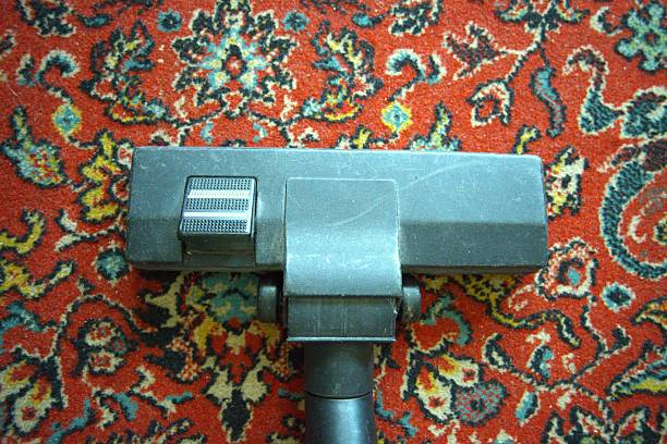 Vacuum cleaner on beige carpet. Cleaning the apartment. Household appliances.