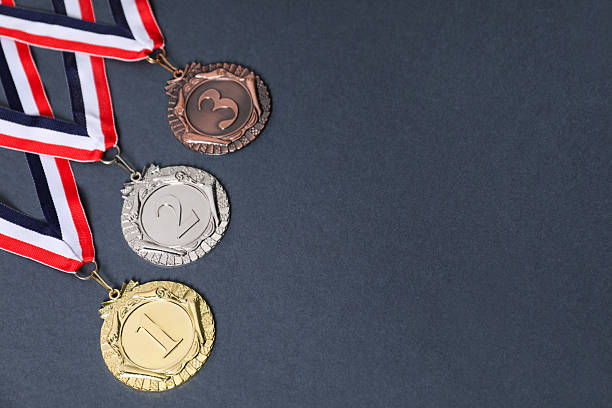 istock Golden, silver and bronze medals on grey background, space for text 2219021429