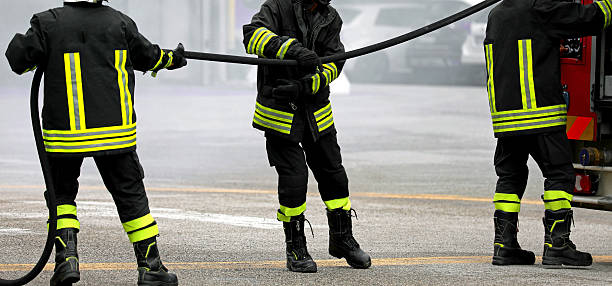 istock three firefighters who take fire hose during emergency in city 2219023801