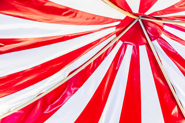 istock Circus tent background. Colorful design, striped white and red, retro style. 2219026327