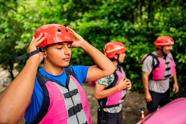 Young man putting sport helmet outdoors