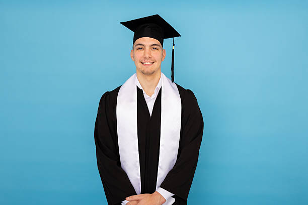 istock Graduate wearing academic regalia, smiling proudly while marking academic achievement milestone 2219029828